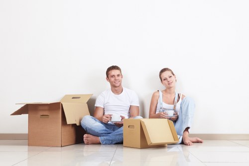 Packed boxes and moving equipment prepared for a home relocation in Swiss Cottage