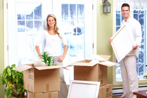 Loading boxes and home items into a van near Swiss Cottage